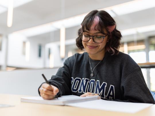 Student writing on a piece of paper